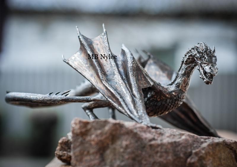 Smaug - dragon from the Hobbit trilogy. Realistic sculpture made of stainless steel
